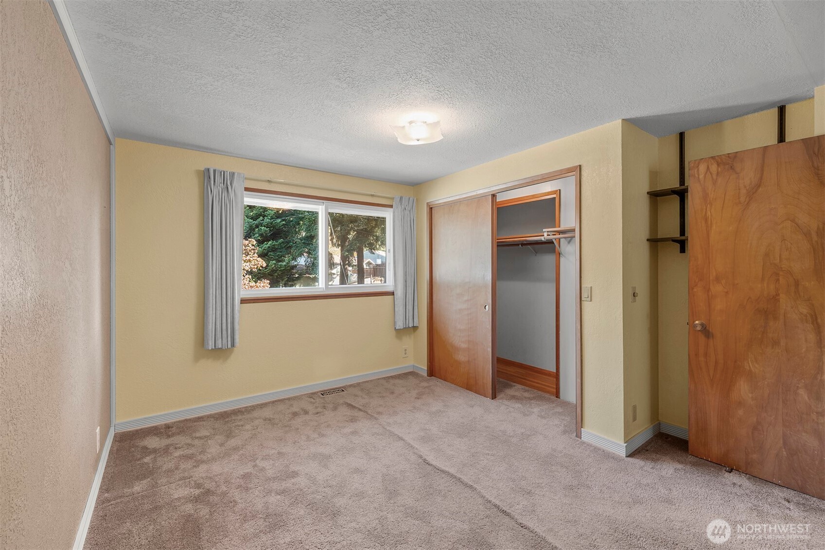 1027 South 112th Street Seattle, WA 98168 - Photo 12 of 33 a view of an empty room with window and closet area