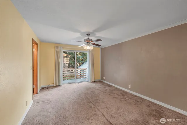 a view of a livingroom with a ceiling fan and window
