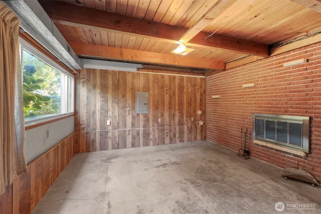 a view of an empty room with a fireplace and a window
