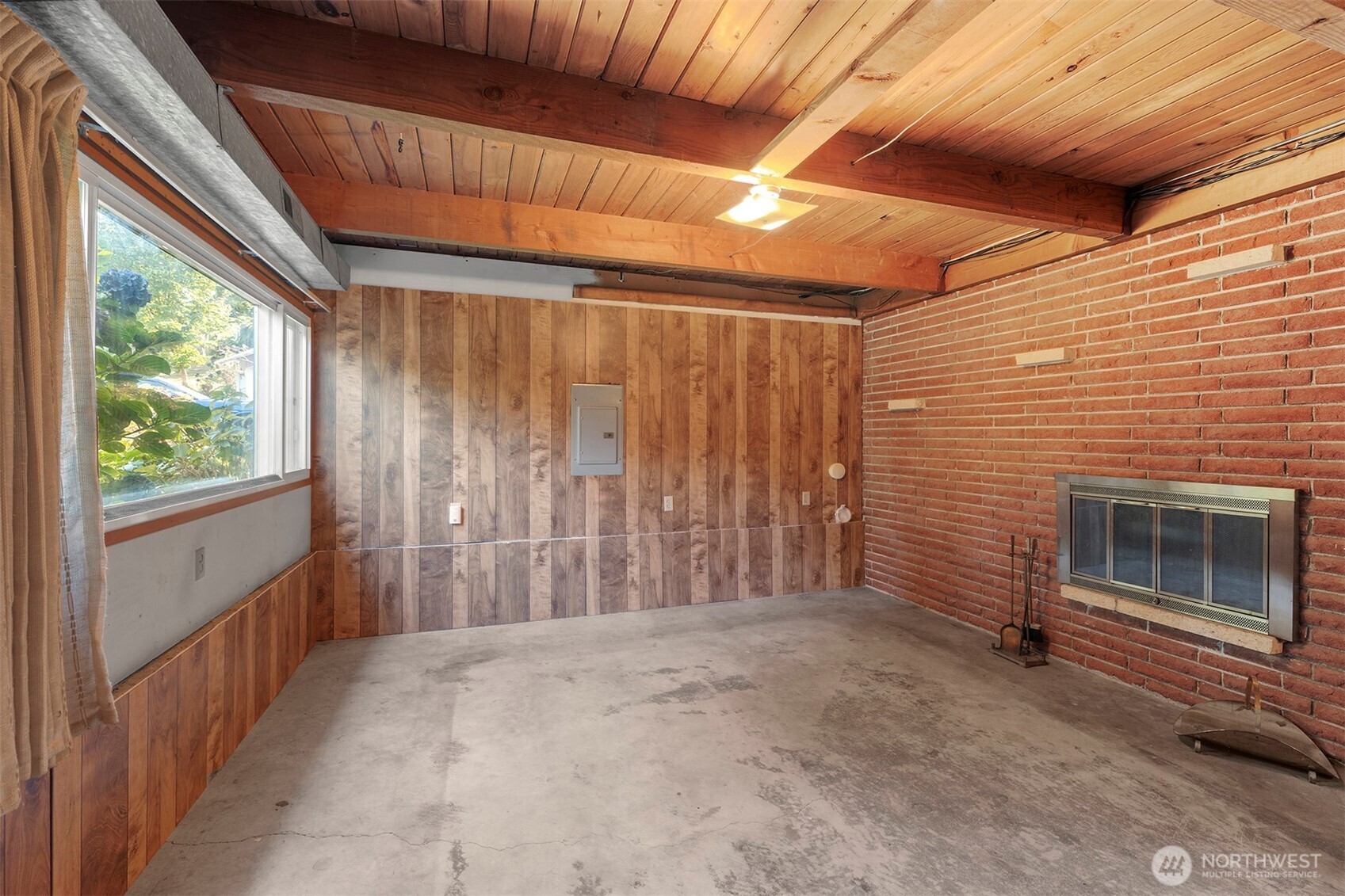 1027 South 112th Street Seattle, WA 98168 - Photo 16 of 33 a view of an empty room with a fireplace and a window