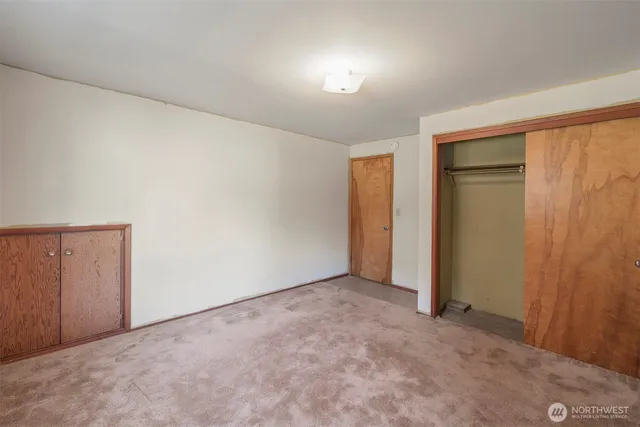 an empty room with closet area