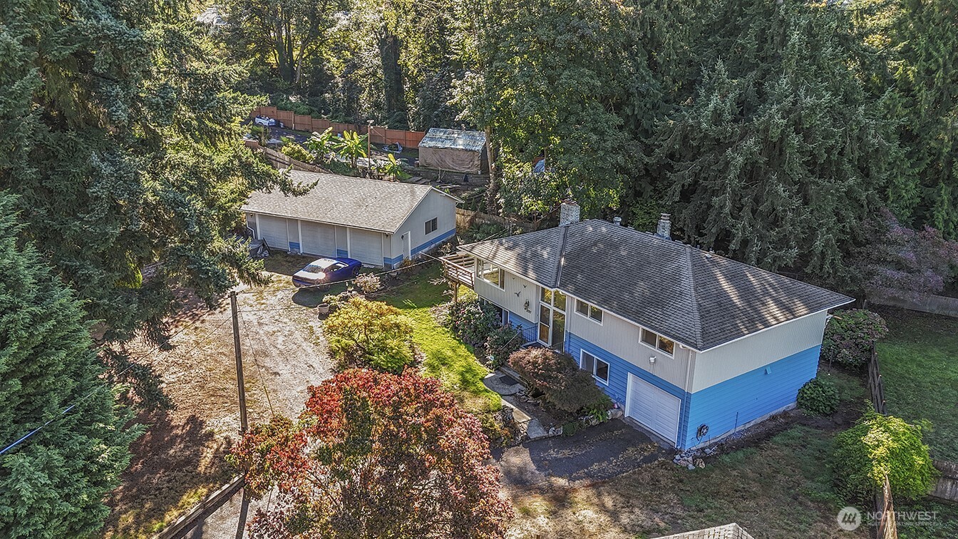 1027 South 112th Street Seattle, WA 98168 - Photo 28 of 33 a aerial view of a house with a yard and large trees