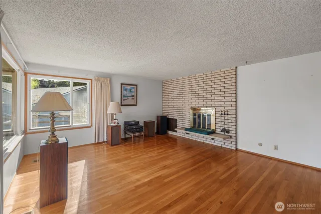 an empty room with furniture and a fireplace