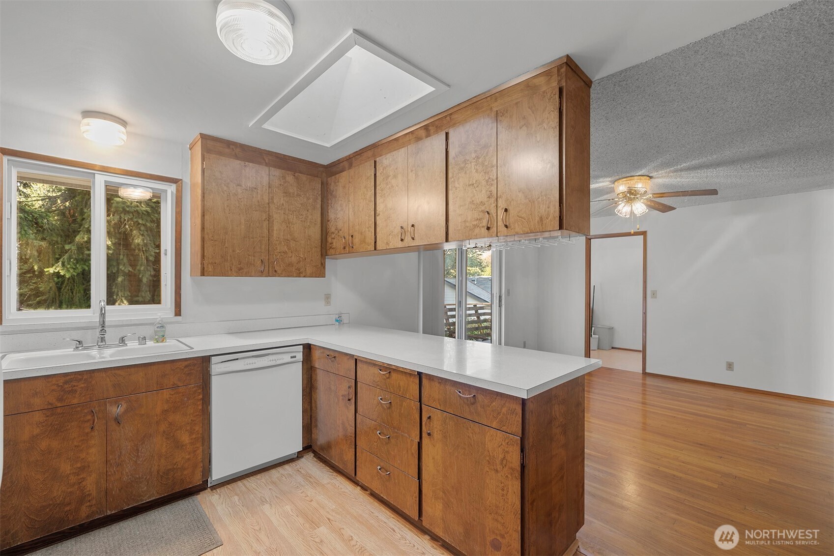 1027 South 112th Street Seattle, WA 98168 - Photo 7 of 33 a kitchen with a sink cabinets and window