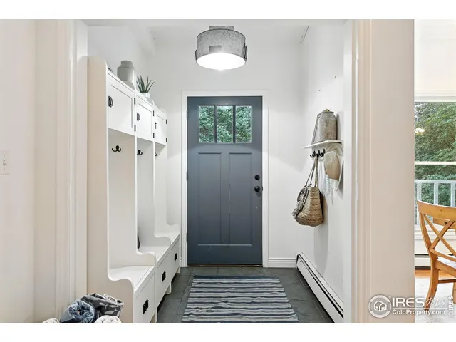 a view of a hallway with a white walls and a window