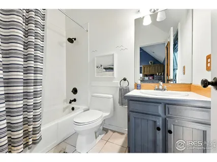 a bathroom with a sink a toilet a mirror a vanity and shower