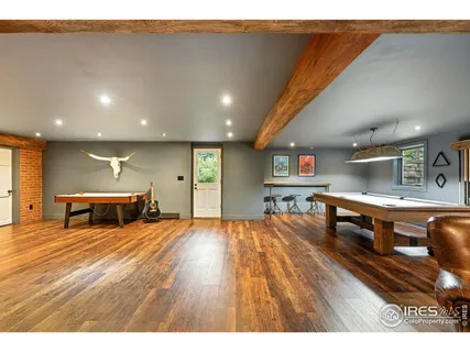 a room with lots of furniture and wooden floors