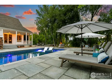 a view of swimming pool with chairs and tables