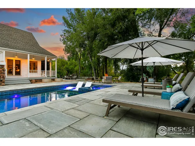 a view of swimming pool with chairs and tables