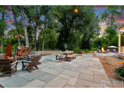 a view of backyard with seating area and trees