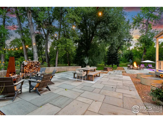 a view of backyard with seating area and trees