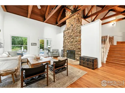 a living room with furniture a fireplace and a table