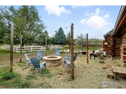 a swimming pool with outdoor seating and yard
