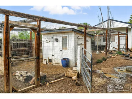 a view of a porch with a table and chairs under an umbrella