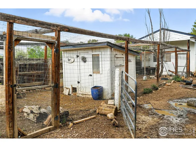 a view of a porch with a table and chairs under an umbrella