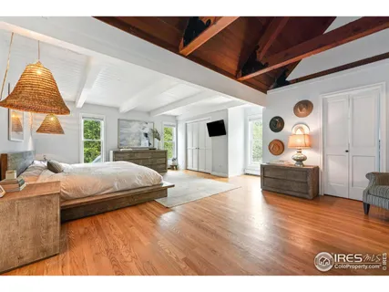 a bedroom with a bed and a large window