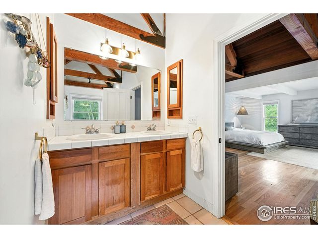 a bathroom with a sink a mirror and a shower