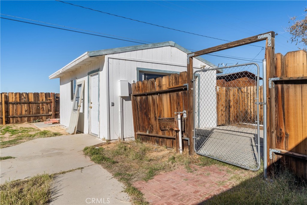 13445 Fran Street Edwards, CA 93523 - Photo 13 of 27 a view of a house with a door and wooden walls