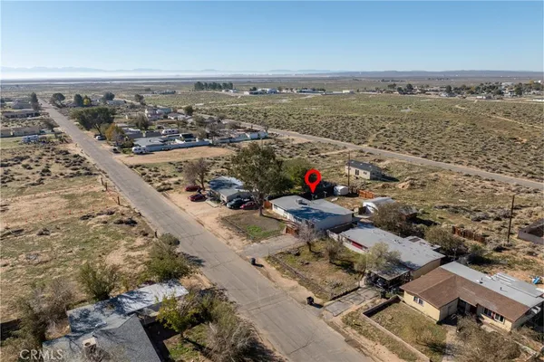 an aerial view of a house with a yard and lake view