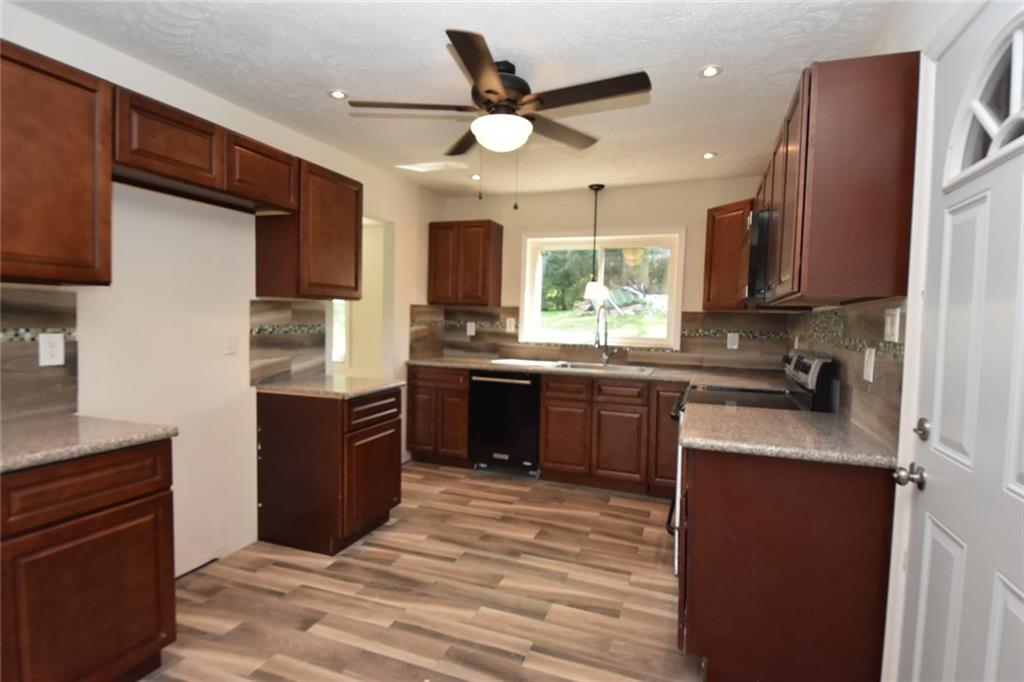 241 Alameda Road Butler, PA 16001 - Photo 12 of 24 Kitchen blends floor tile with decorative ceramic back splash. Floor tile needs reset in some areas.
