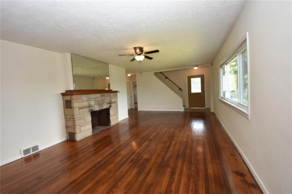 241 Alameda Road Butler, PA 16001 - Photo 14 of 24 Living room with refurbished floors. Fireplace will need evaluated by an expert to ensure operation. The in-law suite is annexed from this room and has it's own full bath.