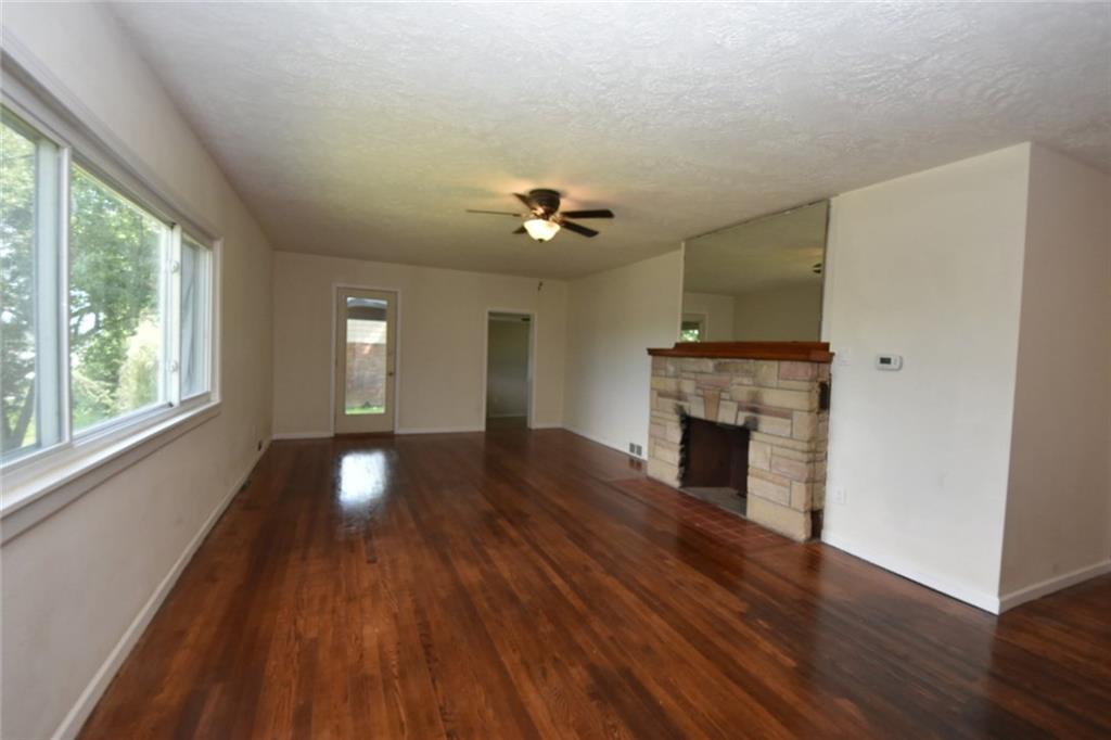 241 Alameda Road Butler, PA 16001 - Photo 3 of 24 Spacious 25' x 13' living room has refinished hardwood floors and fireplace. Windows are vinyl replacement.