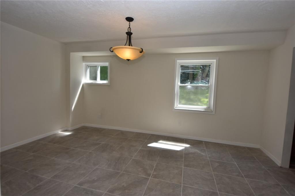 241 Alameda Road Butler, PA 16001 - Photo 4 of 24 Dining room measures 16' x 12' and has newly installed ceramic tile flooring & new light fixture.