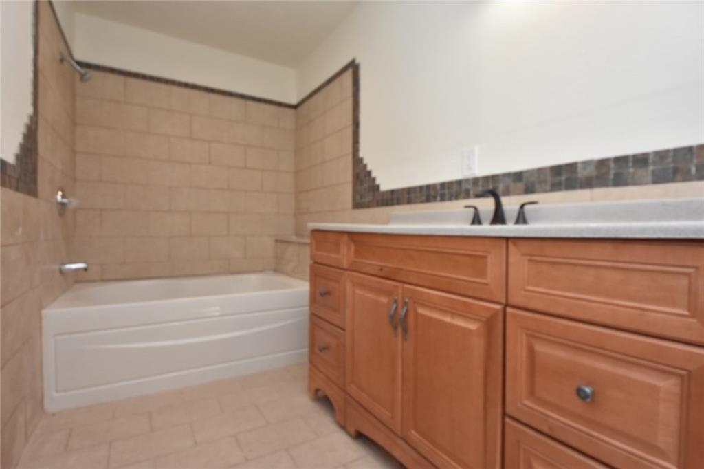 241 Alameda Road Butler, PA 16001 - Photo 9 of 24 Master bathroom needs fit & finish ceramic wall tile work. Vanity needs leveled and centered. A wall mirror should also be installed. Toilet, tub & vanity are newly installed.