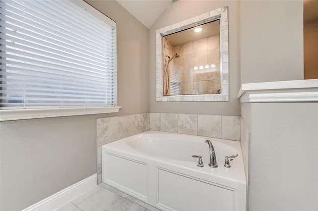 a white bath tub sitting next to a window