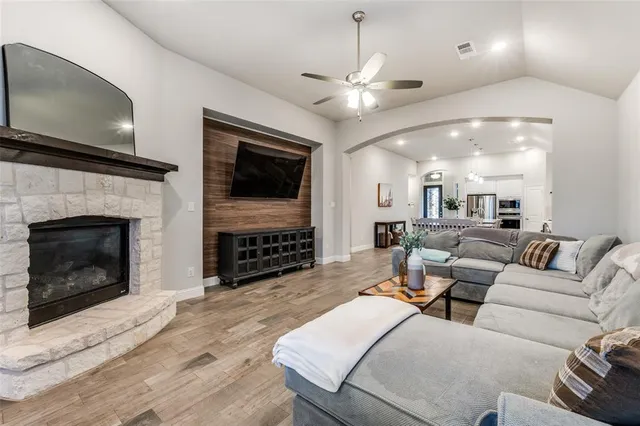 a living room with furniture a fireplace and a flat screen tv