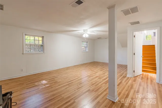wooden floor in an empty room with a window