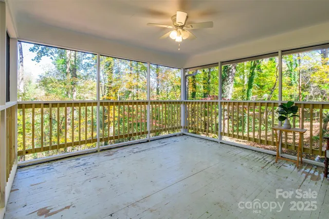 wooden floor in an empty room with a large window