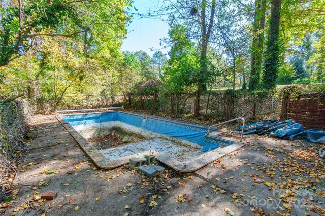 a view of a backyard with swimming pool
