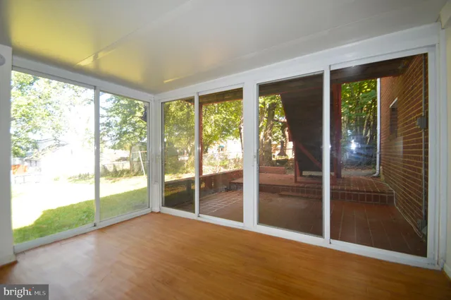a kitchen with stainless steel appliances granite countertop a sink dishwasher and a stove with wooden floor