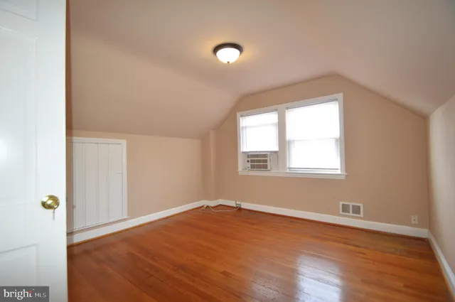 a dining room with furniture a chandelier and wooden floor