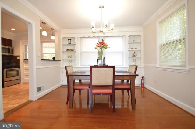 a view of a room with gym equipment and wooden floor