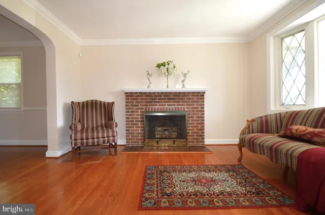 a dining room with furniture a chandelier and wooden floor