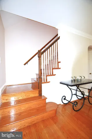 a view of a room with wooden floor and a kitchen