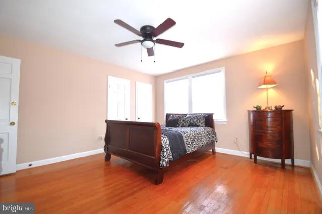 a view of a room with gym equipment and wooden floor