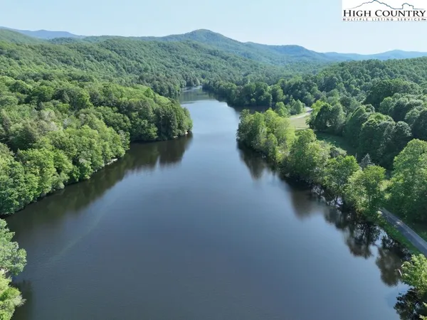 a view of a street with a forest