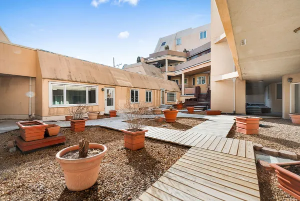 a view of a patio with table and chairs stove with wooden floor