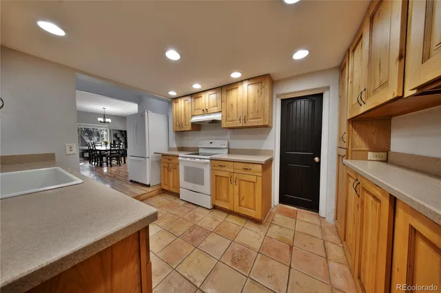 a kitchen with a sink a counter top space stainless steel appliances and cabinets