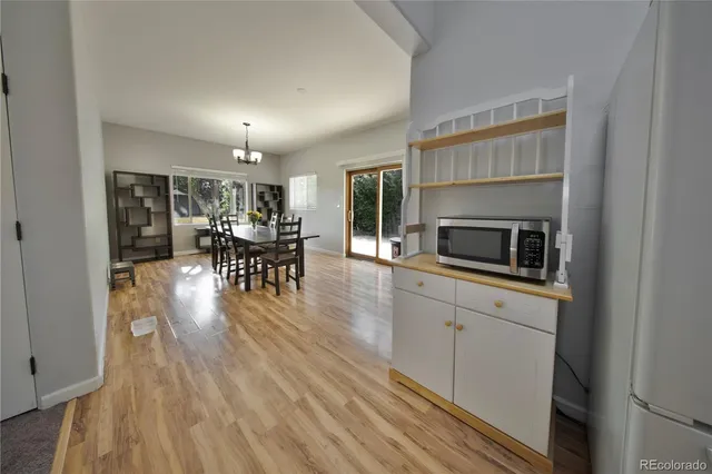 a kitchen with microwave a stove and cabinets