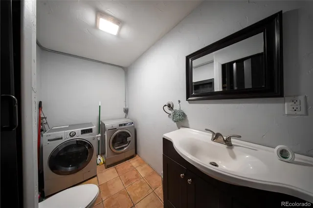 a utility room with sink dryer and washer