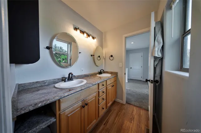 a spacious bathroom with a double vanity sink and a mirror