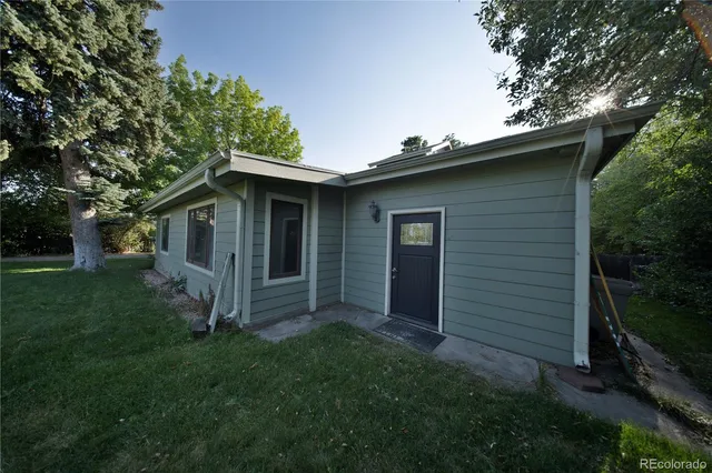 a view of a house with backyard and sitting area