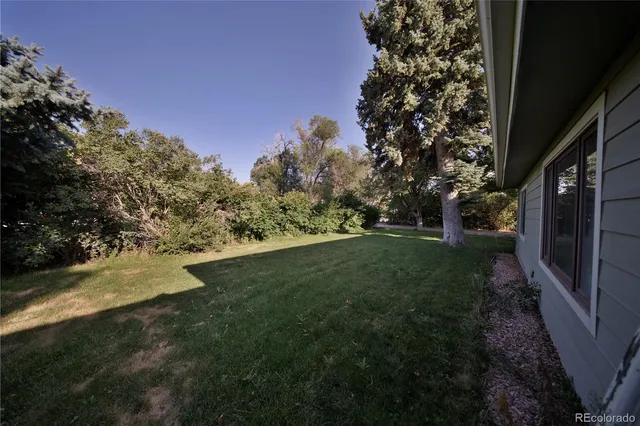 a view of a pathway with a wrought fence
