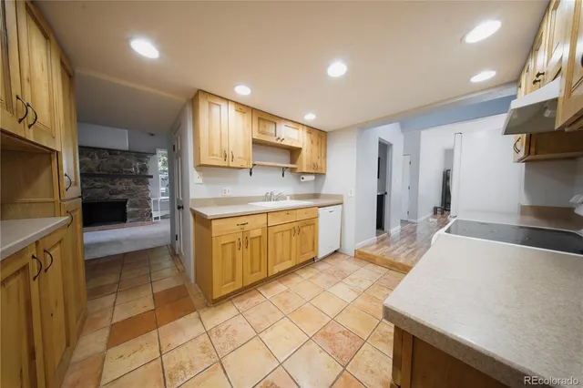 a kitchen with a sink a stove top oven and cabinets