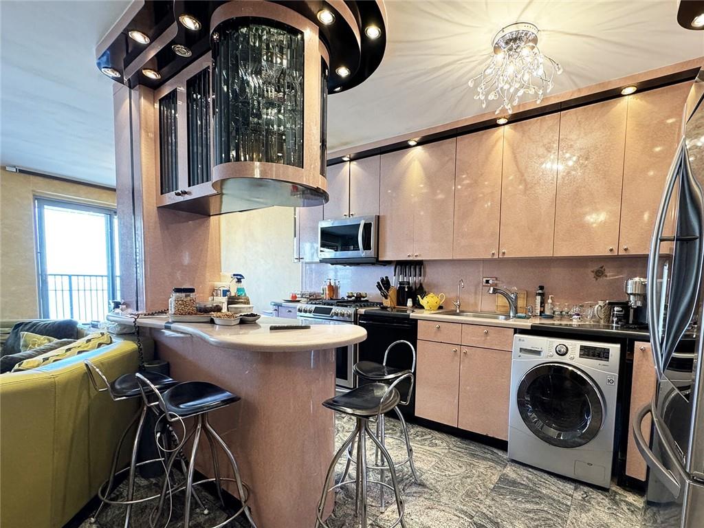 601 Surf Avenue, Unit 18E Brooklyn, NY 11224 - Photo 4 of 24 a kitchen with a sink a stove and cabinets