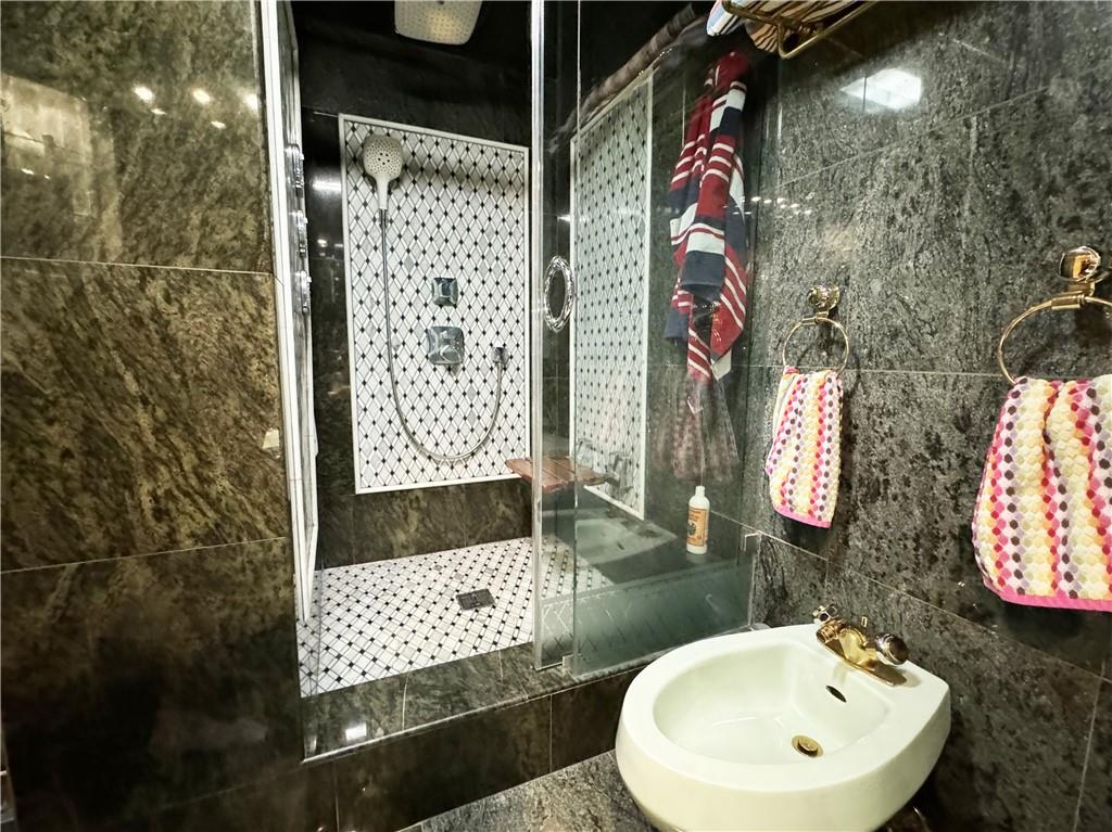 601 Surf Avenue, Unit 18E Brooklyn, NY 11224 - Photo 8 of 24 a bathroom with a sink and a mirror